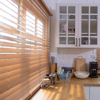Various Kitchen Utensils Set Of Cooking Pots Pans with window blinds in the window